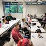 Participants listening to trainer in a classroom setting