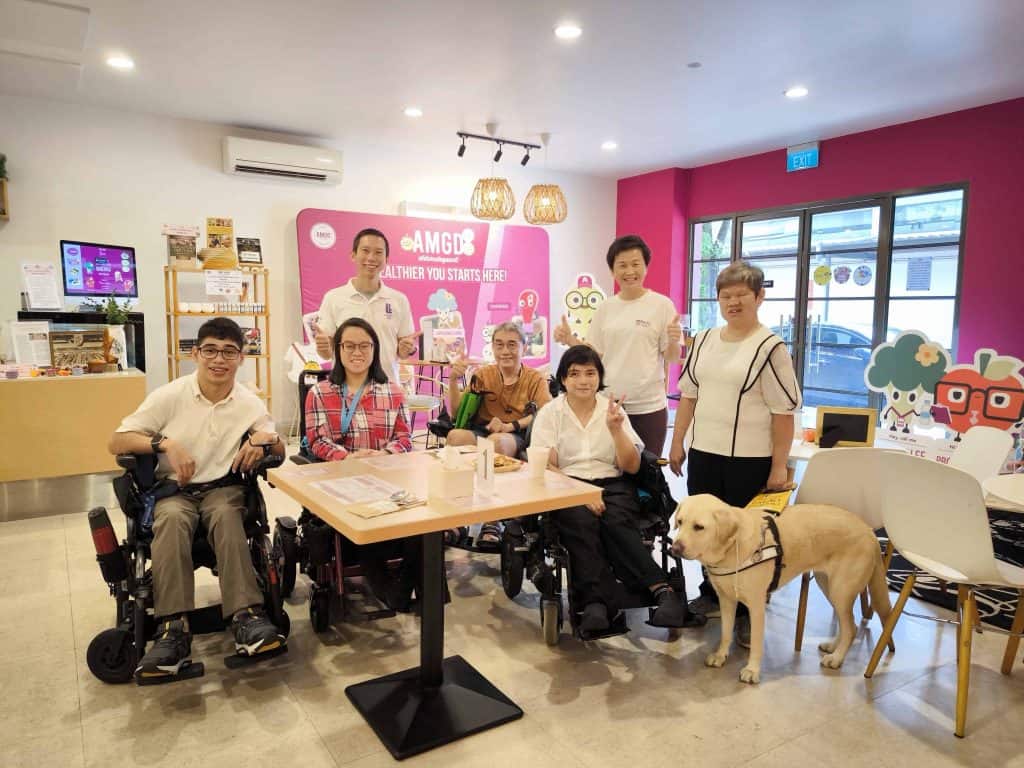 Enabling Village - Group of wheelchair users and Visually impaired with guide dog at AMGD restaurant