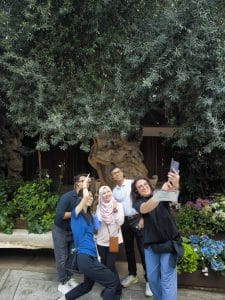 Group of people posing infront of Olive tree in Gardens by the Bay