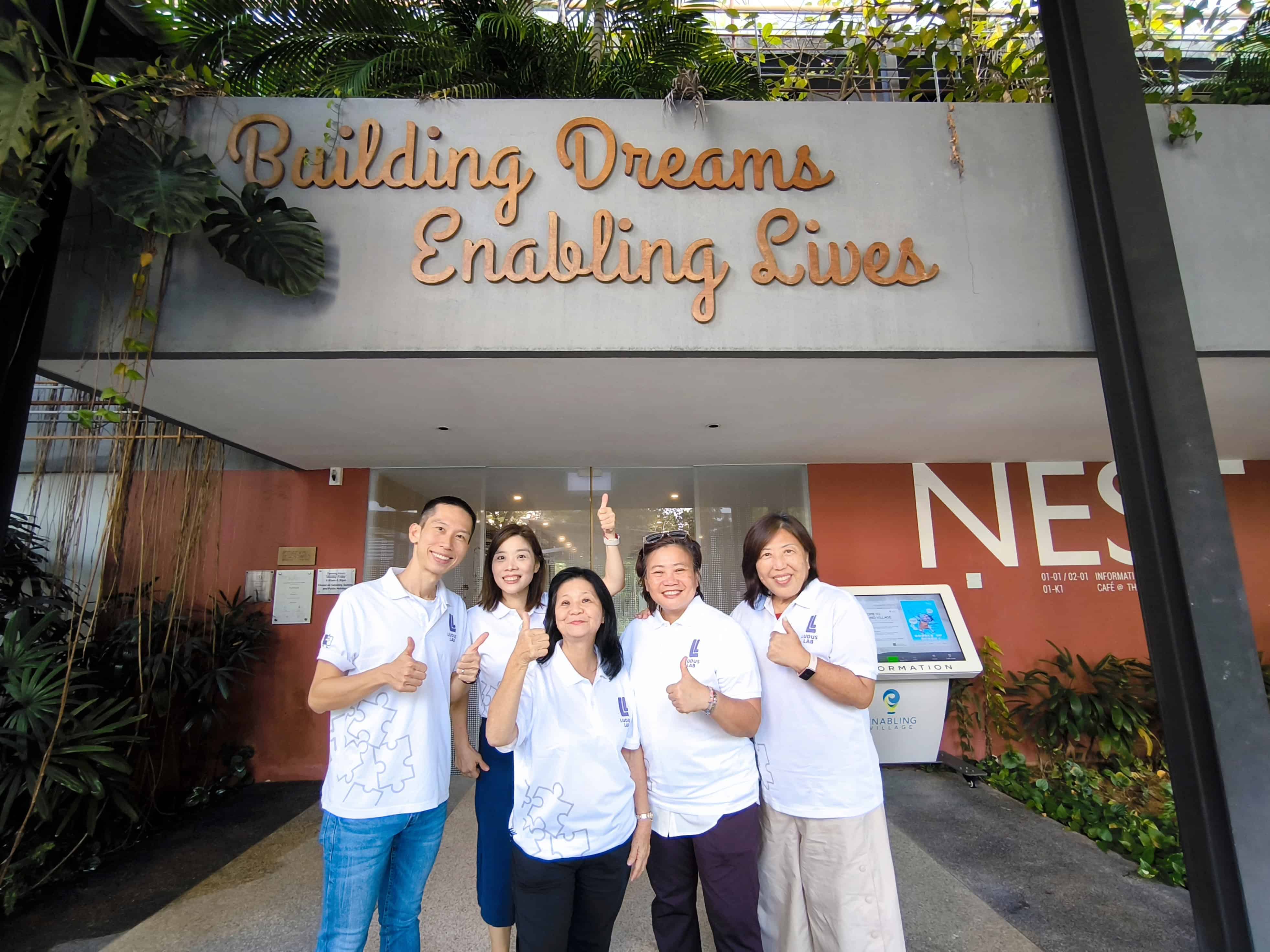 Group of 5 Ludus Lab Trainers in front of Nest @ Enabling Village