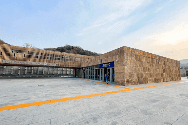 Entrance to Badaling Great Wall Railway Station, with yellow tactile paving across the forecourt.
